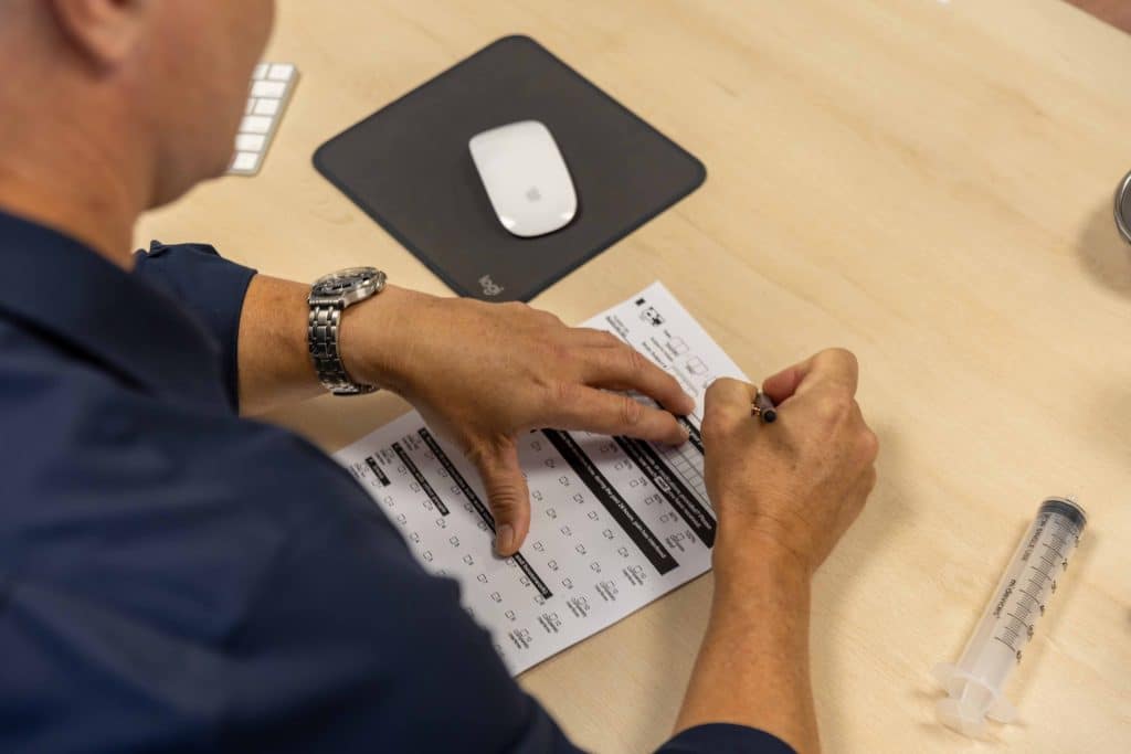 Specialist Pain Physician anthony sayce filling out pain inventory chart