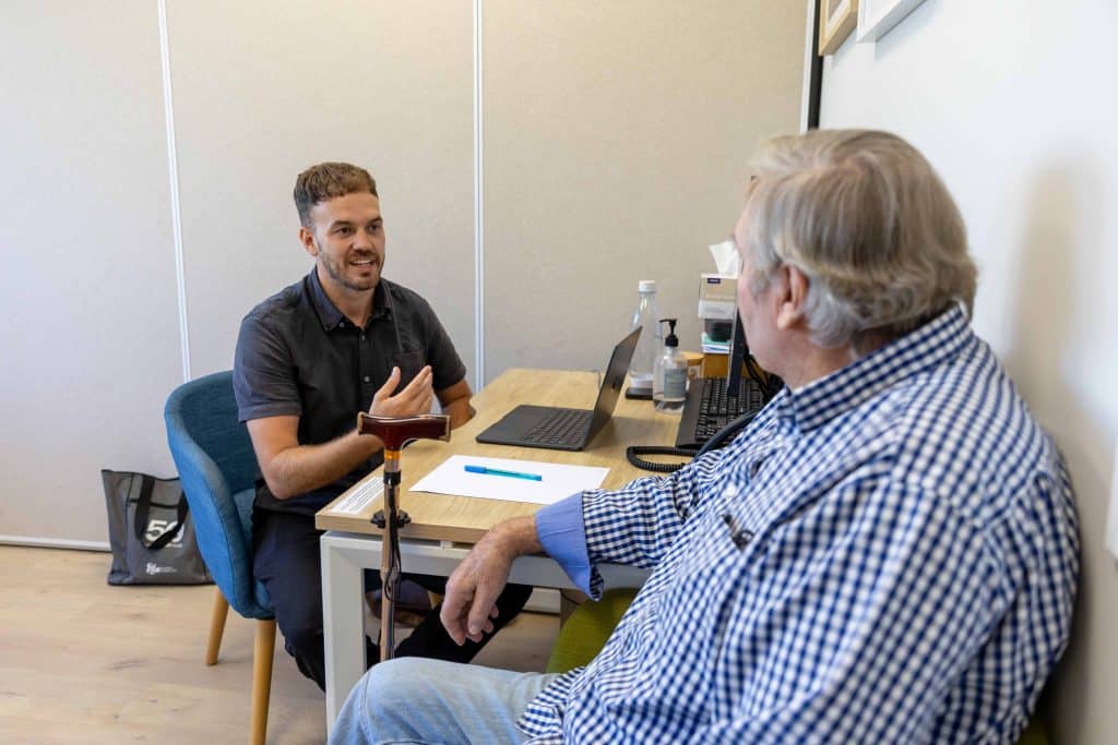 Lachlan Townend physio consulting with patient